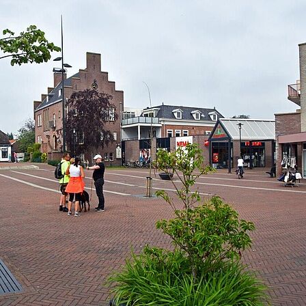 Het dorpsplein van Wervershoof. Op de achtergrond het voormalig gemeentehuis van Wervershoof en de toegang naar het overdekte winkelcentrum.